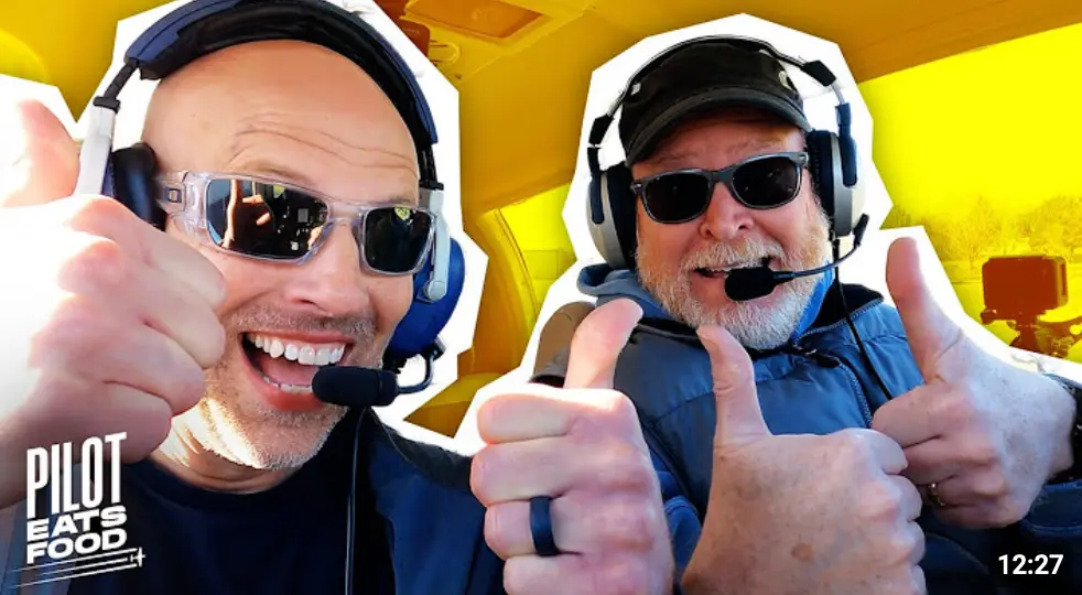 " Jamie and Scott Williamson giving thumbs up in cockpit."